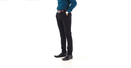 An elegant man puts on black, leather, formal shoes. Isolated over white background and able to add some textの写真素材