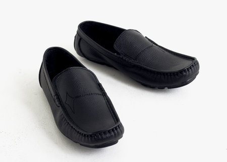 A pair of black leather shoes isolated on a white background.の写真素材