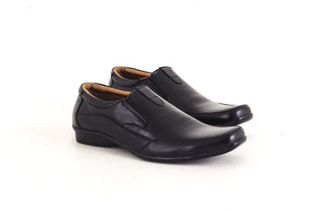 Black leather shoes isolated on white background. Shallow depth of field.の写真素材