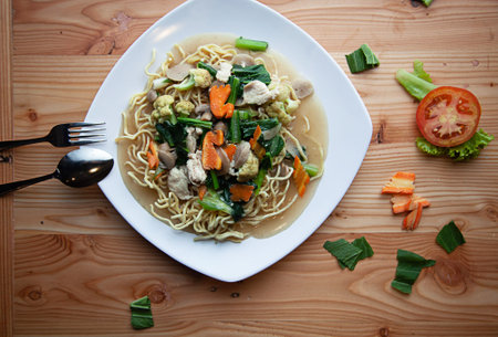 Noodles boiled on a white plate.Mie rebus.Mie Kuah. instant noodles from Indonesia. Top viewの写真素材
