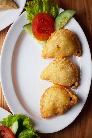 Curry Puff (Kari Pap) or Pastel Goreng is Pastry Popular in Indonesia. Fried pastry with filling of sautÃ©ed vegetable, chicken and boiled egg. accompanied with sauce and mayonnaiseの写真素材