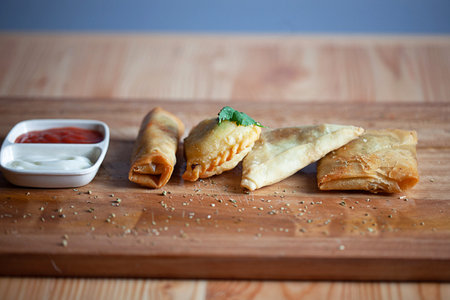 Curry Puff (Kari Pap) or Pastel Goreng is Pastry Popular in Indonesia. Fried pastry with filling of sautÃ©ed vegetable, chicken and boiled egg. accompanied with sauce and mayonnaiseの写真素材