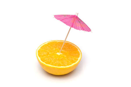 Juicy orange with parasol on white backgroundの写真素材