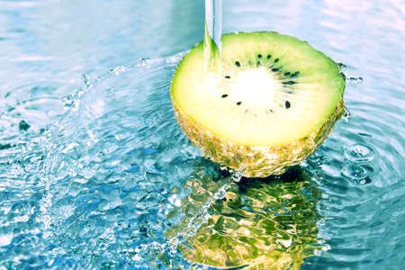 Kiwi in water splashの写真素材