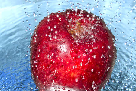 Apple in water splashの写真素材
