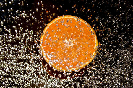 Orange in water splashの写真素材