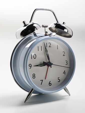 an old fashioned alarm clock with chrome bells shot on a white backgroundの写真素材