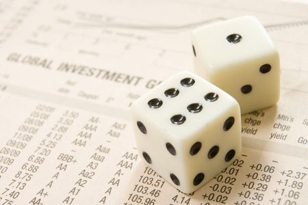 pair of dice with stocks and sharesin background