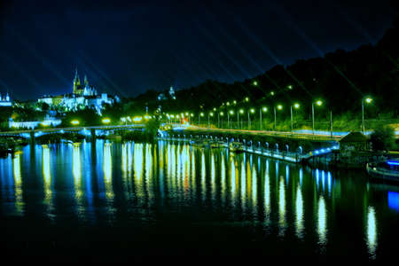 The Prague Castle overlooking the Vlatva river is a magnificent sight to witness at night.の写真素材