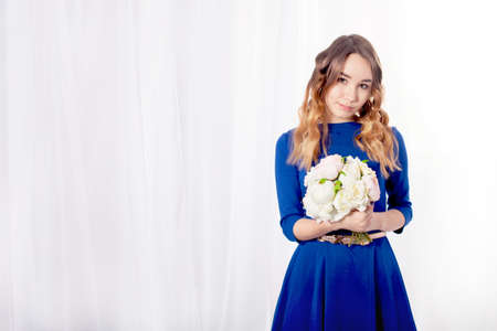 Girl with a bouquet on a white background curtainの写真素材
