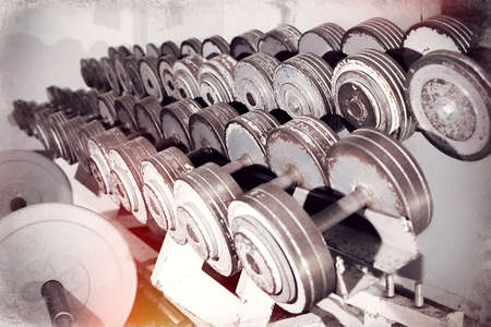Old dumbbells row. Metallic gray with shabby paintの写真素材