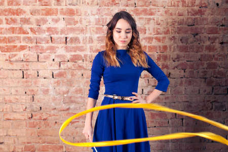Girl magic with a ribbon. Brick wallの写真素材