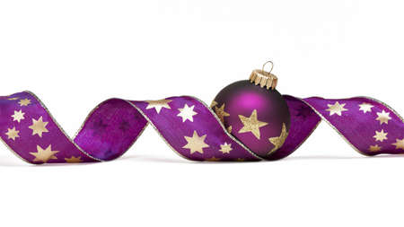 Christmas tree ball with curly ribbon isolated on whiteの写真素材