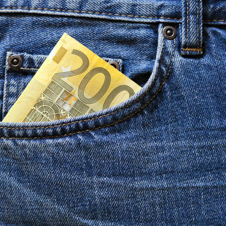 100 euro note in a blue jeans pocket の写真素材