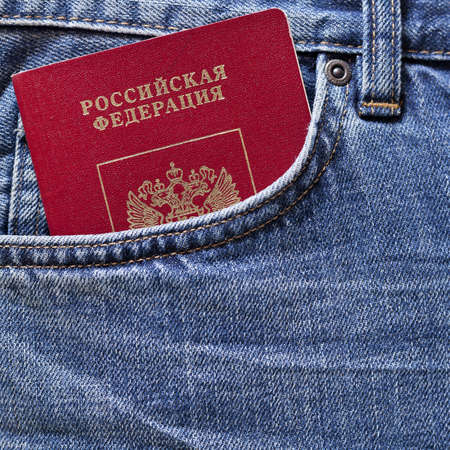 Red Russian passport in pocket of blue jeansの写真素材