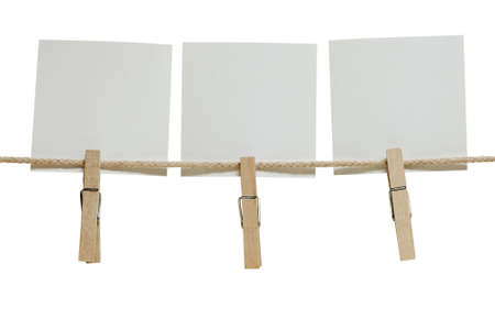 Close up of post it reminders and clothespins attached to a rope on white backgroundの写真素材