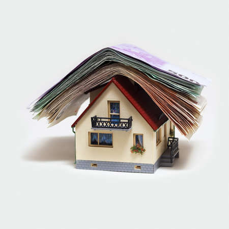 House with Euro banknotes on white backgroundの写真素材