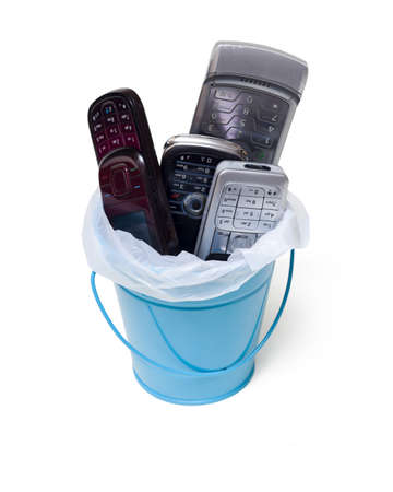 garbage can filled with old  cell phones , isolated on white の写真素材