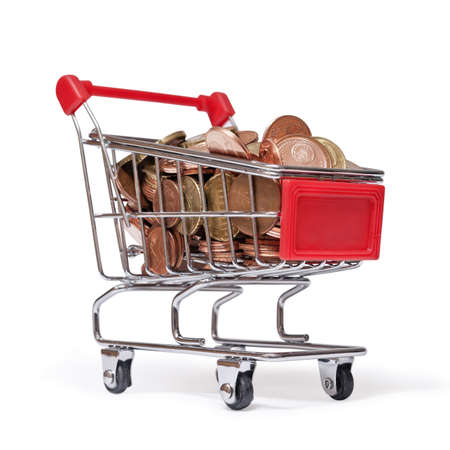 a shopping cart is filled with well-euro coins on white backgroundの写真素材
