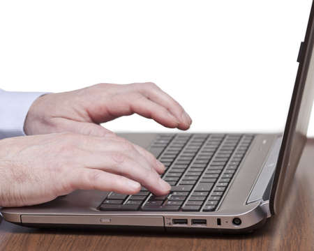 Men hands typing on a keyboard of laptop の写真素材