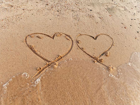two hearts on the sand beachの写真素材