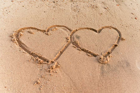 two hearts on the sand beach の写真素材