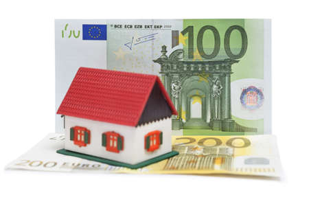 House with Euro banknotes over white backgroundの写真素材