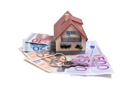 House with Euro banknotes and house key over white backgroundの写真素材