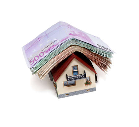 House with Euro banknotes  over white backgroundの写真素材