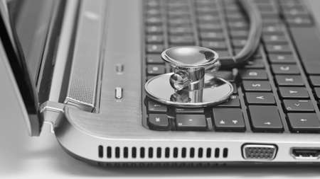Close-up of stethoscope on laptop keyboard