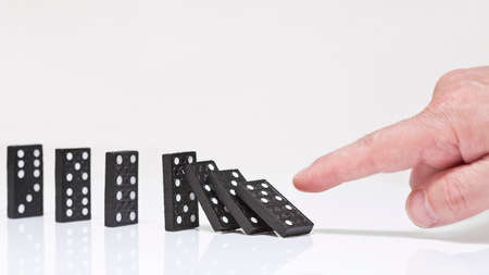 Finger toppling dominoes. Domino effect.の写真素材