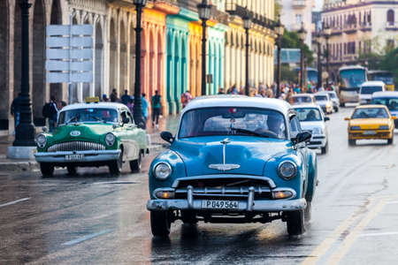 Havana, Cuba 2016.01.22 Retro classic American cars drive on the rainy roads round Parc Centrale in Havana, Cuba.のeditorial素材