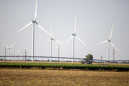 ONeill, Nebraska, US July 22, 2019 Wind Farm In Nebraska Farm Land Wind Power Turbine Up Close. A windmill on top of a grass covered field. High quality photoのeditorial素材