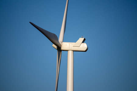 ONeill, Nebraska, US July 22, 2019 Wind Farm In Nebraska Farm Land Wind Power Turbine Up Close. A windmill on top of a grass covered field. High quality photoのeditorial素材