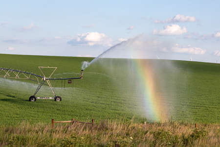 Pivot running in field with beauful rainbow on sunny day . July 22, 2019, ONell, Holt county, Nebraskaのeditorial素材
