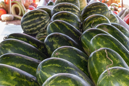 Side angle view of rows of Watermelons in the Farmers Market . High quality photoの写真素材
