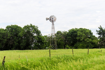 Old Rustic Windmill on Nebraska pasture landscape . High quality photoの写真素材