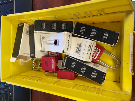 Lock out tag out locks locks in a yellow tote. High quality photo