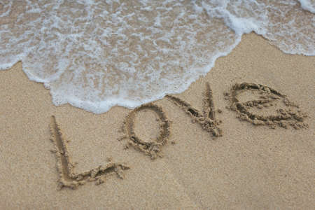 LOVE spelled on sand on beach in Hawaiiの写真素材