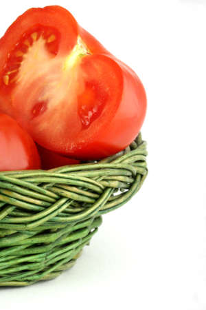 Fresh and ripe tomatoes in the wicker basketの写真素材