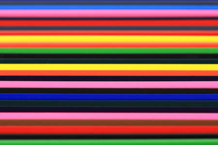 Many coloured pencils together in a rowの写真素材