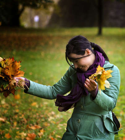 woman with fallen leavesの写真素材