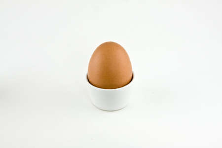 egg in a cup isolated on a white backgroundの写真素材