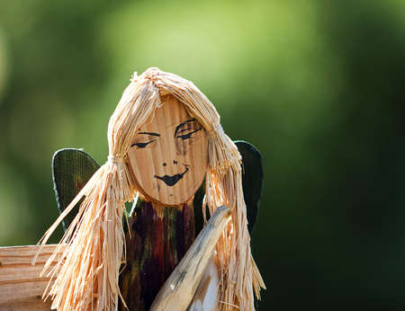 wodden handmade carving of an angel-woman faceの写真素材