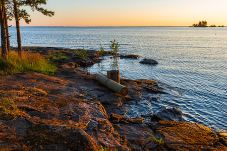 The shore of the lake is flooded with the morning sun. The wonderful island Valaam is located on Lake Lodozhskoye, Karelia. Balaam - a step to heavenの写真素材