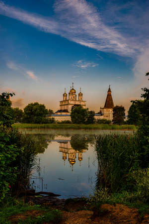 Sunrise over the Cathedral of the Joseph-Volotsky Monastery. Beautiful lake near the Joseph-Volotsky...