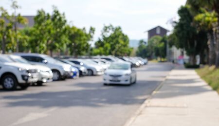 Abstract blurred background of outdoor car park in outlet store with sunlight (defocus)の写真素材