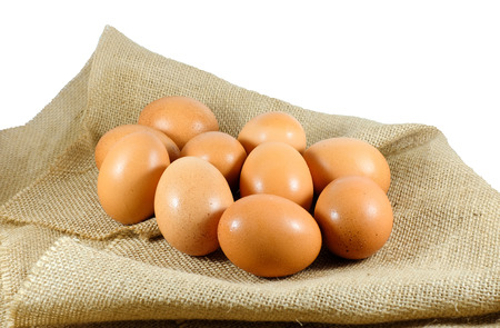 Closed up chicken eggs on sack cloth with background.の写真素材