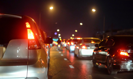 Traffic jams in the city with row of cars on the road at night and bokeh lights in BANGKOK,THAILAND (with selective focus)の写真素材