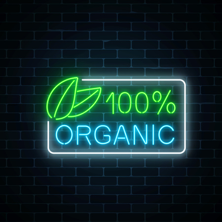 Neon 100 percent organic production sign on dark brick wall background.のイラスト素材
